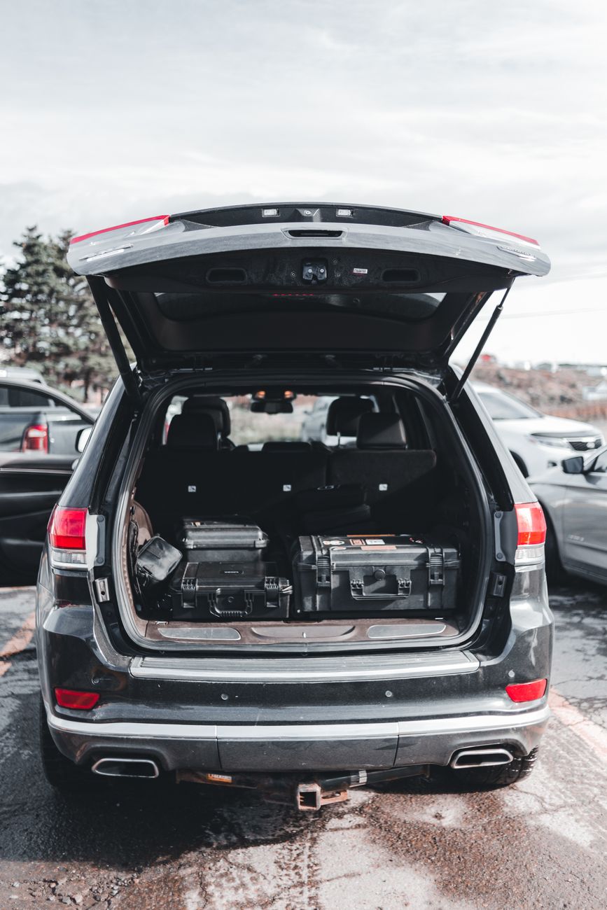 an open trunk of a car with black cases